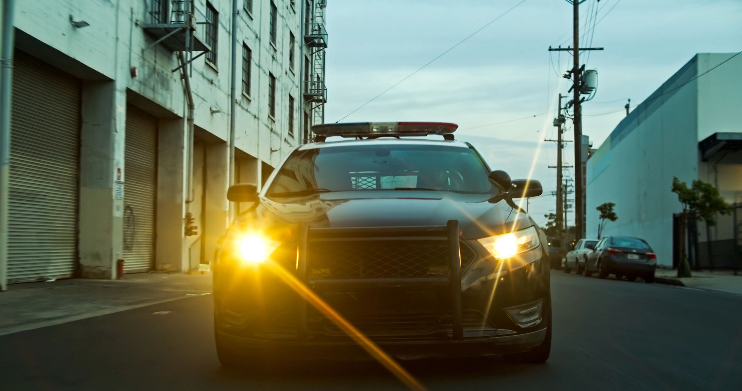 Front view of an emergency vehicle with lights on in the evening